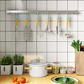 Kitchen Utensils With Wooden Handles Hanging On Gray Tiled Wall Near White Pot And Jars