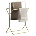 Bathroom Towel Rack with Golden Metal Frame Holding Brown and Light Gray Towels