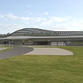 Modern Streamlined Terminal Building Design With Green Landscaping And Roadway Surroundings