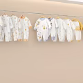 Cute Baby Onesies Hanging Display With White Yellow Blue Colors And Adorable Patterns