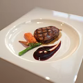Grilled Steak Plated with Green Vegetables Carrots and Red Sauce on White Square Plate