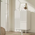 White Vertical Slat Design Cabinet In Living Room Corner With Natural Light And Decorative Items