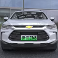 Silver Chevrolet SUV Featuring Green License Plate And Front Grille Design