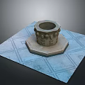 Stone Carved Circular Pedestal On Blue Square Mat With Geometric Pattern And Decorative Carvings