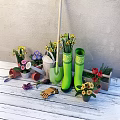 Decorative Ornament Combination With Green Rain Boots Daffodils Tulips Flower Pots And Garden Tools