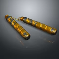 Ornate Gold And Black Nunchucks With Decorative Patterns And Connecting Chain