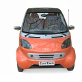 Orange Small Two Seater Car With Silver Accents And Unique Wheel Design