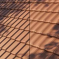 Brown Interlocking Roof Tiles With Curved Edges And Overlapping Design