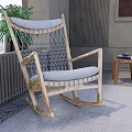 Natural Wooden Rocker Leisure Chair With Gray Cushion And Woven Backrest In Cozy Room