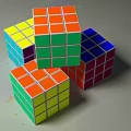 Colorful Rubik's Cubes Stacked With Vibrant Multicolored Faces On Gray Surface
