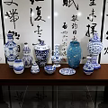 Traditional Chinese Calligraphy Art with Blue and White Porcelain on Wooden Table