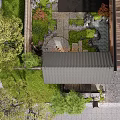 Japanese Courtyard Garden Featuring Wooden Gate Black Tiled Roof Lanterns Stone Path And Mossy Rocks