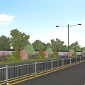Municipal Road With Street Lamps Green Belts Trees Guardrails And Vehicles