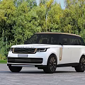 White Range Rover Luxury SUV With Modern Sleek Design And Green Trees Background