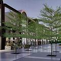 Vibrant Commercial Street Shopping Area With Trees Street Lamps And Storefronts
