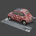 Red Small Car Covered With Various Colorful Stickers Parked On Road