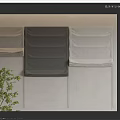 Fabric Curtains in Different Gray Tones Displayed on Beige Wall with Green Plant Accent