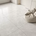 Modern Light Gray Marble Floor Tiles In Minimalist Interior With Beige Bean Bag