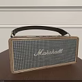 Marshall Portable Speaker With Wooden Frame Leather Handle On Wooden Table White Wall Background