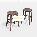 Two Round Wooden Stools With Natural Wood Grain And Carved Legs