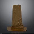 Golden Obelisk Sculpture with Intricate Carved Patterns on Stable Base