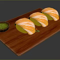 Yellow Striped Sushi on Wooden Cutting Board with Green Sauce and Colorful Garnishes