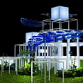 Illuminated White Cube Structures With Blue Leaf Decorations And Green Grass Plants 3d model