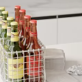 Assorted Bottles in Metal Wire Basket with Paper Towels on Counter