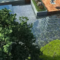 Lush Garden Courtyard with Water Feature Greenery and Wooden Deck Design