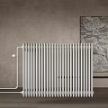 White Vertical Radiator for Home Heating in Room with Gray Wall and Decorative Art