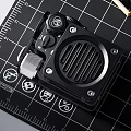 Professional Black Portable Speaker with Grille Design on Measuring Mat and Workshop Tools