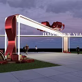 Event Gateway with Happy New Year Sign Red Bow Under Sunset Sky and People Walking