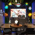 Modern Bar Interior Design With Green Plants Hanging Lights Neon Accents And Wine Racks