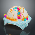 Round Dome Shaped Cake With White Frosting And Colorful Decorations On Blue White Checkered Napkin
