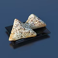 Two Triangular Oat Topped Pastries With Golden Crust On Black Plate