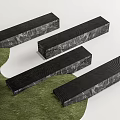 Black Long Strip Landscape Seats With Textured Surface On Green Grass And White Background