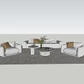 Modern Sofa Set With Light Colored Pillows Round Coffee Table Potted Plant And Area Rug