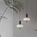 Two Modern Pendant Lights With White Shades Black Bases On Neutral Wall With Leafy Plant