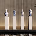 Ceramic Vases in Blue and White Design on White Pedestals with Gold Vertical Striped Wall