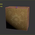 Golden Decorative Box With Intricate Floral Patterns And Green Gemstone On Top