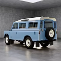 Classic Blue Off Road Vehicle With Vintage Design Roof Windows And White Wall Wheels