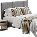 Modern Bedroom Interior With Gray Headboard White Comforter Striped Pillows And Nightstand