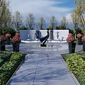 Scenic Park Landscape With Stone Pathway Black Sculpture Lush Green Plants And Flower Beds