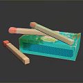 Colorful Wooden Matches With Orange Tips And Green Patterned Matchbox