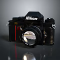 Nikon Vintage Camera With Black Body Red Stripe And Classic Lens