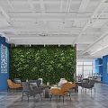 Modern Lounge Area With Green Living Wall Blue Wall White Typography Sofas And Coffee Tables