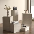 Concrete Pedestals Display with Vase Flowers Black Handbag Books and High Heels in Room with Wooden Floor