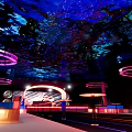 Modern Bar With Deep Blue Purple Lighting Starry Cosmic Ceiling Circular Neon Decorations And Seating