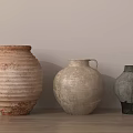 Three Decorative Ceramic Vases With Textured Surfaces In Neutral Tones On Wooden Table