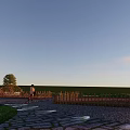 Tranquil Outdoor Garden Scene With Stone Path Wooden Fence Trees Person And Evening Light